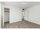 Bedroom features wood-look flooring, a closet, and two doors at 2117 W 2Nd St, Mesa, AZ 85201