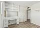 Bright bedroom with a built-in vanity/desk area, wood-look floors, and a neutral palette at 2117 W 2Nd St, Mesa, AZ 85201