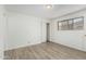 Bedroom with wood-look flooring, a window, and a closet at 2117 W 2Nd St, Mesa, AZ 85201