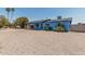Exterior front view of light blue single story home with covered porch and gravel yard at 2117 W 2Nd St, Mesa, AZ 85201