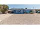 Front exterior view of single story light blue home with a covered porch and gravel yard at 2117 W 2Nd St, Mesa, AZ 85201
