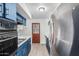 Kitchen boasts blue cabinets, white countertops, and stainless steel appliances at 2117 W 2Nd St, Mesa, AZ 85201