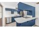 Stylish kitchen with stainless steel appliances, white countertops, and blue cabinetry at 2117 W 2Nd St, Mesa, AZ 85201