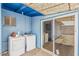 Exterior laundry area with side-by-side washer and dryer and a sliding glass door at 2117 W 2Nd St, Mesa, AZ 85201