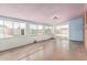 Empty sunroom with many windows, sliding door to backyard, and light fixture at 2117 W 2Nd St, Mesa, AZ 85201