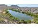 Scenic aerial view of a lakeside community, surrounded by lush greenery and serene waters at 22019 N 59Th Dr, Glendale, AZ 85310