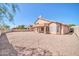 A covered patio extends from the house to a generously sized gravel backyard with mountain views at 22019 N 59Th Dr, Glendale, AZ 85310