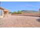 Expansive backyard featuring desert landscaping, block wall, and covered patio at 22019 N 59Th Dr, Glendale, AZ 85310