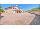 Large gravel backyard featuring ample space, block wall fencing, and a covered patio, ideal for outdoor enjoyment at 22019 N 59Th Dr, Glendale, AZ 85310