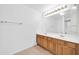 Bathroom features a double sink vanity with a large mirror and tiled floors at 22019 N 59Th Dr, Glendale, AZ 85310