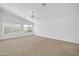 Large bedroom featuring neutral carpet, ceiling fan, and dual windows at 22019 N 59Th Dr, Glendale, AZ 85310