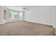 Bright bedroom featuring neutral carpet, ceiling fan, and large windows at 22019 N 59Th Dr, Glendale, AZ 85310