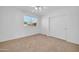 Bedroom featuring a window with blinds, carpet flooring, and closet doors at 22019 N 59Th Dr, Glendale, AZ 85310