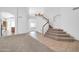 Elegant entryway with a grand staircase and views of the living spaces and kitchen at 22019 N 59Th Dr, Glendale, AZ 85310