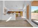 Open-concept kitchen featuring wood cabinetry and a breakfast bar leading to dining and living area at 22019 N 59Th Dr, Glendale, AZ 85310