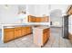 Spacious kitchen featuring tile flooring, light wood cabinets, an island, and stainless appliances at 22019 N 59Th Dr, Glendale, AZ 85310