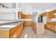 Spacious kitchen featuring tile flooring, light wood cabinets, an island, and stainless appliances at 22019 N 59Th Dr, Glendale, AZ 85310