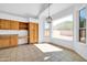 Breakfast nook with tile flooring, built-in cabinetry, and a large window overlooking the yard at 22019 N 59Th Dr, Glendale, AZ 85310