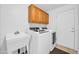 Laundry room with modern washer, dryer, sink, and ample cabinet storage at 22019 N 59Th Dr, Glendale, AZ 85310
