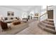 Inviting living room features a cozy seating area and staircase leading to the upper level at 22019 N 59Th Dr, Glendale, AZ 85310