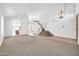 Open concept living room showcasing staircase, with seamless flow into the kitchen at 22019 N 59Th Dr, Glendale, AZ 85310