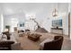 Open-concept living room with high ceilings, staircase, and views into the kitchen area at 22019 N 59Th Dr, Glendale, AZ 85310