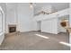 Spacious living room featuring a fireplace, soaring ceiling, and access to the second-floor loft at 22019 N 59Th Dr, Glendale, AZ 85310