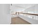 Bright loft view with wooden railing and neutral carpet at 22019 N 59Th Dr, Glendale, AZ 85310