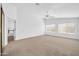 Spacious main bedroom featuring neutral carpet, ceiling fan, and many windows at 22019 N 59Th Dr, Glendale, AZ 85310