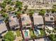 Aerial view of a property featuring a sparkling swimming pool, patio, and well-maintained landscaping at 2213 N Park Meadows Dr, Buckeye, AZ 85396