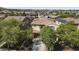 Aerial view of a home with desert landscaping, a tile roof, and solar panels in a residential neighborhood at 2213 N Park Meadows Dr, Buckeye, AZ 85396