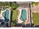 An aerial shows two adjacent backyard pools, one with a pergola, the other a diving board at 2213 N Park Meadows Dr, Buckeye, AZ 85396