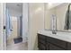 Bathroom featuring a dark wood vanity, a sink, and an open view to the shower area with a curtain at 2213 N Park Meadows Dr, Buckeye, AZ 85396