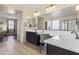 Spacious bathroom featuring a double vanity, large mirror, and a chair at 2213 N Park Meadows Dr, Buckeye, AZ 85396