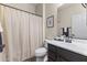 Cozy bathroom features a single vanity, framed mirror and a bathtub with shower at 2213 N Park Meadows Dr, Buckeye, AZ 85396