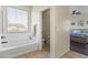 Bright bathroom with a soaking tub and separate toilet room at 2213 N Park Meadows Dr, Buckeye, AZ 85396