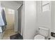 Bright, clean bathroom featuring a toilet, shower with curtain, and a window for natural light at 2213 N Park Meadows Dr, Buckeye, AZ 85396