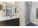 Well-lit bathroom featuring a vanity with dark wood cabinets and a shower with a gray curtain at 2213 N Park Meadows Dr, Buckeye, AZ 85396