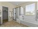 Modern bathroom showcasing a glass-enclosed shower and a large soaking tub at 2213 N Park Meadows Dr, Buckeye, AZ 85396