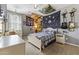 Eclectic bedroom with tapestries, a white bed frame, and guitars decorating the walls at 2213 N Park Meadows Dr, Buckeye, AZ 85396