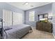 Comfortable bedroom with carpet floors, neutral walls, and a sliding door closet at 2213 N Park Meadows Dr, Buckeye, AZ 85396