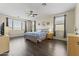 Bright bedroom with a large window, ceiling fan, and a comfortable bed at 2213 N Park Meadows Dr, Buckeye, AZ 85396