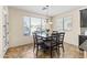 Dining room features a dark wood table set next to a window with wood blinds at 2213 N Park Meadows Dr, Buckeye, AZ 85396
