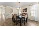 Traditional dining room featuring a chandelier, staircase, and tiled flooring with a window at 2213 N Park Meadows Dr, Buckeye, AZ 85396