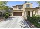 Charming two-story home with arched entryway, brown garage door, and well-maintained landscaping at 2213 N Park Meadows Dr, Buckeye, AZ 85396