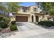 Charming two-story home with arched entryway, brown garage door, and mature landscaping at 2213 N Park Meadows Dr, Buckeye, AZ 85396
