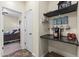 Hallway with built-in coffee bar next to bedroom and neutral walls at 2213 N Park Meadows Dr, Buckeye, AZ 85396