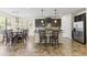 Spacious kitchen featuring an island with seating and adjacent dining area with abundant natural light at 2213 N Park Meadows Dr, Buckeye, AZ 85396