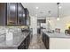 Dark wood cabinets and granite countertops are highlighted in this home's inviting kitchen at 2213 N Park Meadows Dr, Buckeye, AZ 85396