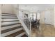 View of staircase leading to dining room with pendant light and tiled floor in neutral colors at 2213 N Park Meadows Dr, Buckeye, AZ 85396